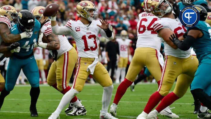 The San Francisco 49ers offensive line buys quarterback Brock Purdy (13) time as he targets a receiver late in the first quarter.