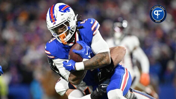 Buffalo Bills running back James Cook (4) is tackled by Denver Broncos safety P.J. Locke in the second quarter at Highmark Stadium.