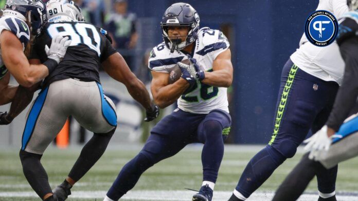 Seattle Seahawks running back Zach Charbonnet (26) rushes against the Carolina Panthers during the fourth quarter at Lumen Field.