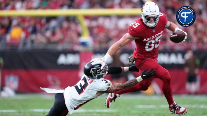 Arizona Cardinals tight end Trey McBride (85) delivers a stiff arm to Atlanta Falcons safety Jessie Bates III (3) during the first half at State Farm Stadium.