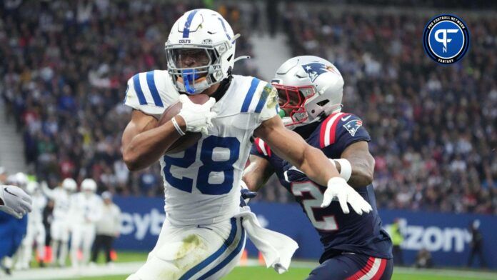 Indianapolis Colts running back Jonathan Taylor (28) scores on a 1-yard touchdown run against New England Patriots cornerback Jalen Mills (2) in the first half during an NFL International Series game at Deutsche Bank Park.