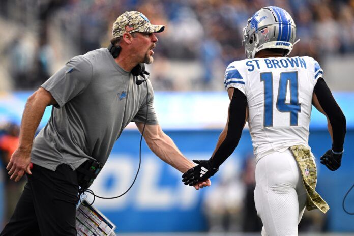 Detroit Lions head coach Dan Campbell (left) congratulates wide receiver Amon-Ra St. Brown (14) after a Lions touchdown against the Los Angeles Chargers during the first half at SoFi Stadium.