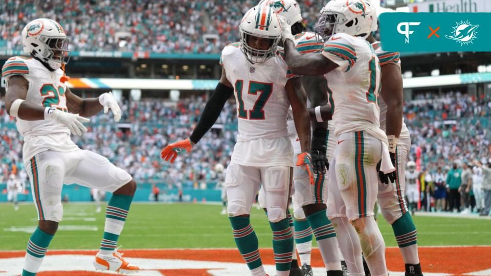 Miami Dolphins WR Jaylen Waddle (17) celebrates with teammates after a touchdown.