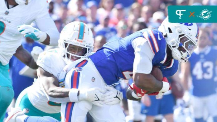 Buffalo Bills running back James Cook (4) is tackled by Miami Dolphins cornerback Kelvin Joseph (9) in the first quarter at Highmark Stadium.