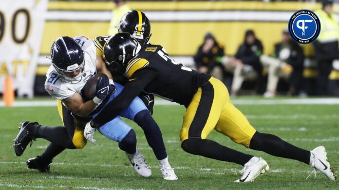 Tennessee Titans WR Kyle Philips (18) is tackled by Pittsburgh Steelers defenders after a catch.