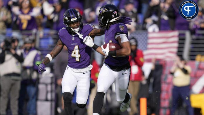 Keaton Mitchell (34) celebrates with wide receiver Zay Flowers (4) after scoring a touchdown against the Cleveland Browns during the first quarter at M&T Bank Stadium.