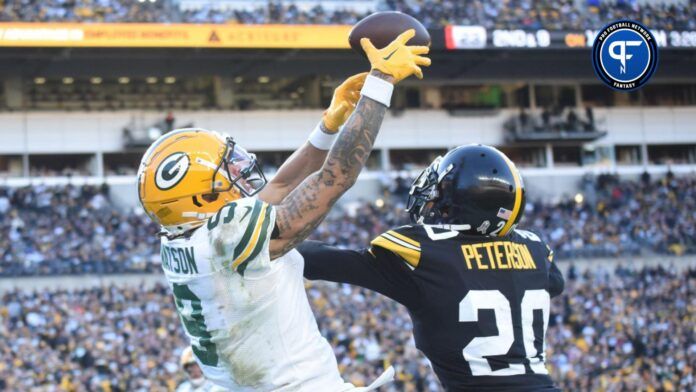 A pass intended for Green Bay Packers wide receiver Christian Watson (9) is tipped by Pittsburgh Steelers cornerback Patrick Peterson (20) before being intercepted by safety Keanu Neal (31) during the fourth quarter at Acrisure Stadium.