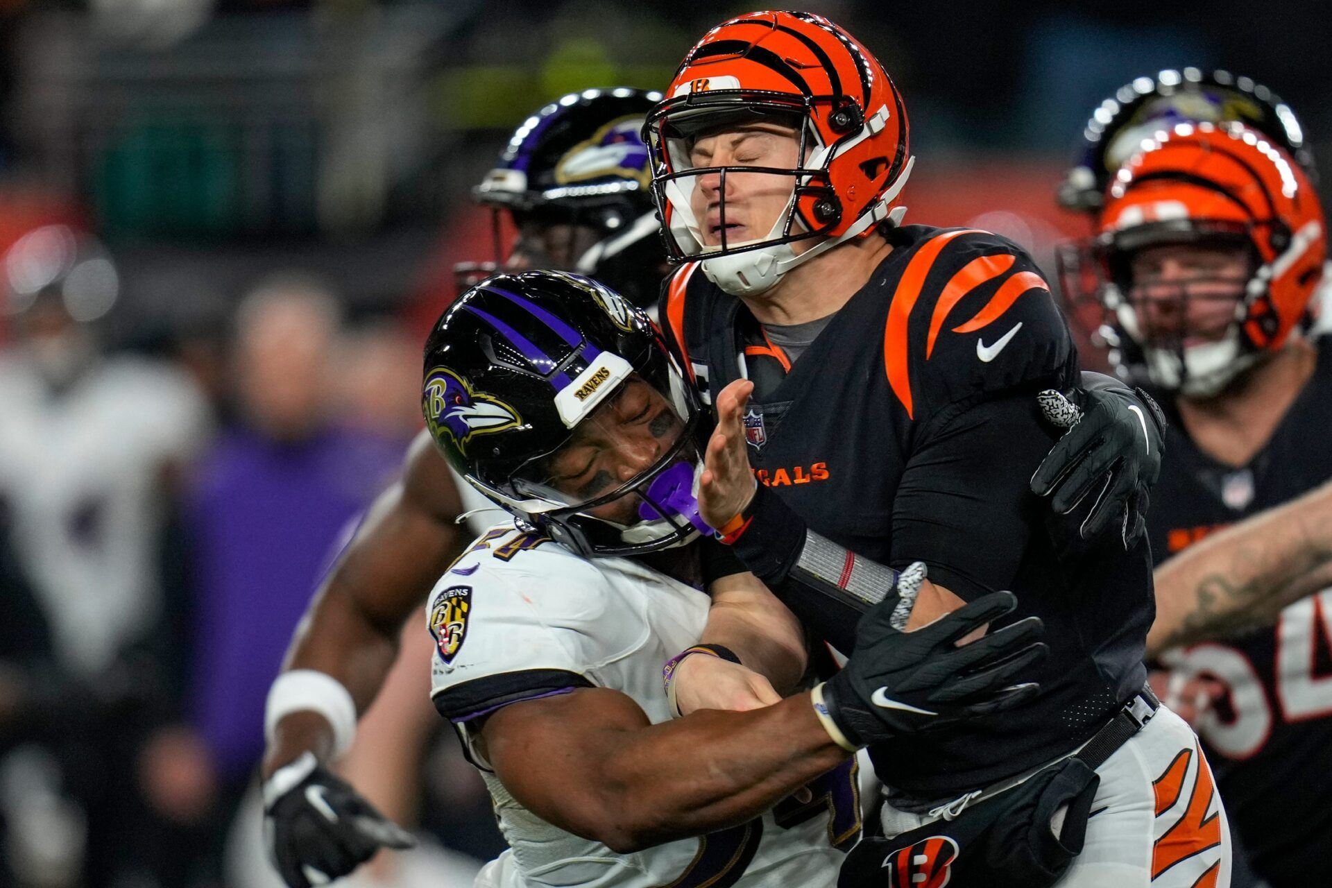 Cincinnati Bengals QB Joe Burrow (9) is hit by Baltimore Ravens LB Kristian Welch (57).