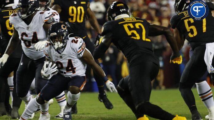 Chicago Bears running back Khalil Herbert (24) carries the ball as Washington Commanders linebacker Jamin Davis (52) chases.