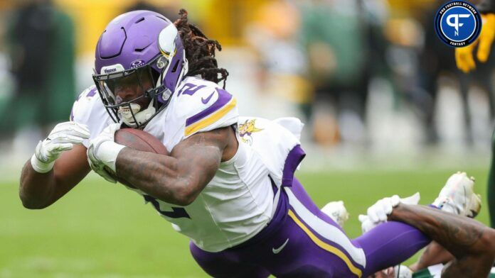 Minnesota Vikings running back Alexander Mattison (2) dives forward for extra yardage against the Green Bay Packers in the game at Lambeau Field.