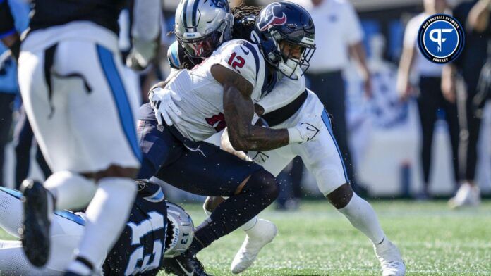 Houston Texans WR Nico Collins (12) is tackled by Carolina Panthers CB Troy Hill (13).