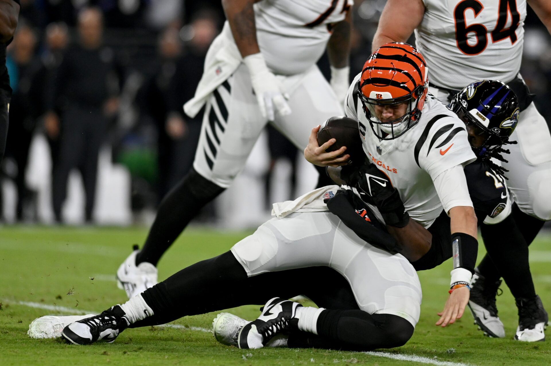 Baltimore Ravens linebacker Jadeveon Clowney (24) sacks Cincinnati Bengals quarterback Joe Burrow (9).