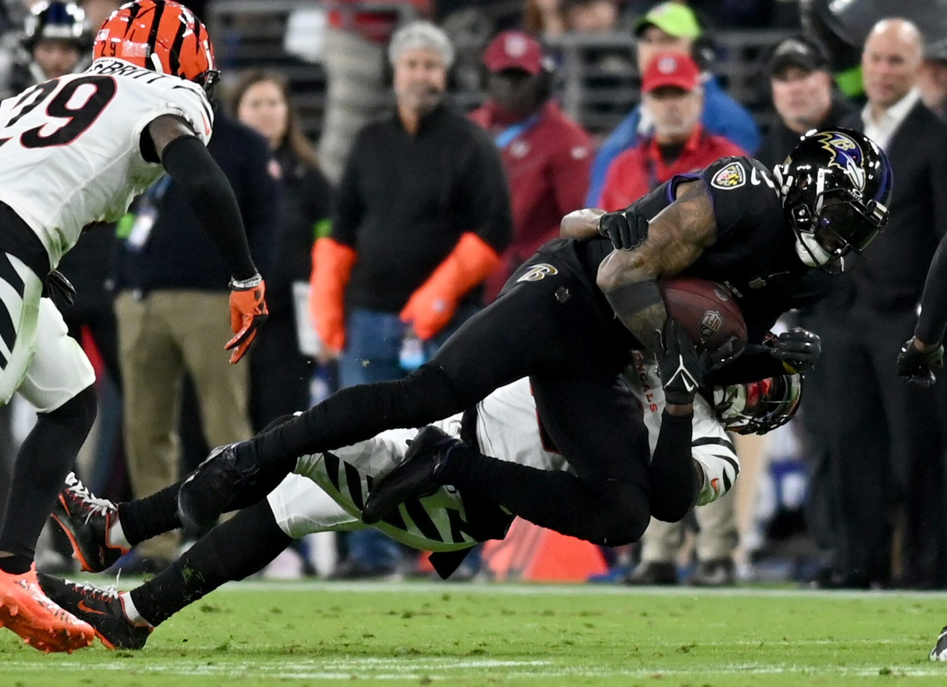 Cincinnati Bengals CB Cam Taylor-Britt (29) tackles Baltimore Ravens WR Odell Beckham Jr. (3).