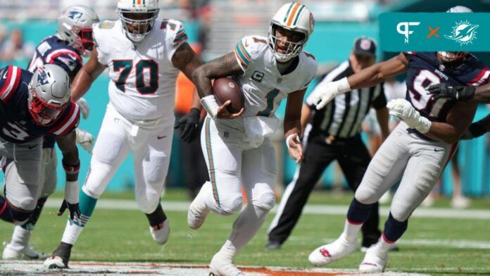 Miami Dolphins QB Tua Tagovailoa (1) runs with the ball against the New England Patriots.