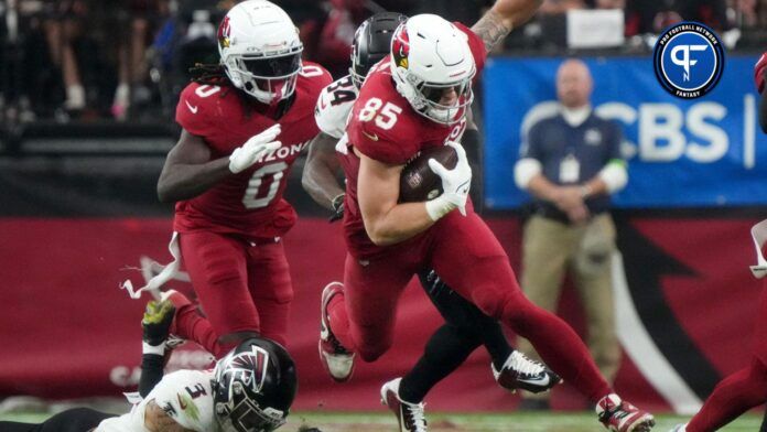 Arizona Cardinals tight end Trey McBride (85) leaps over Atlanta Falcons safety Jessie Bates III (3) at State Farm Stadium on Nov. 12, 2023, in Glendale.