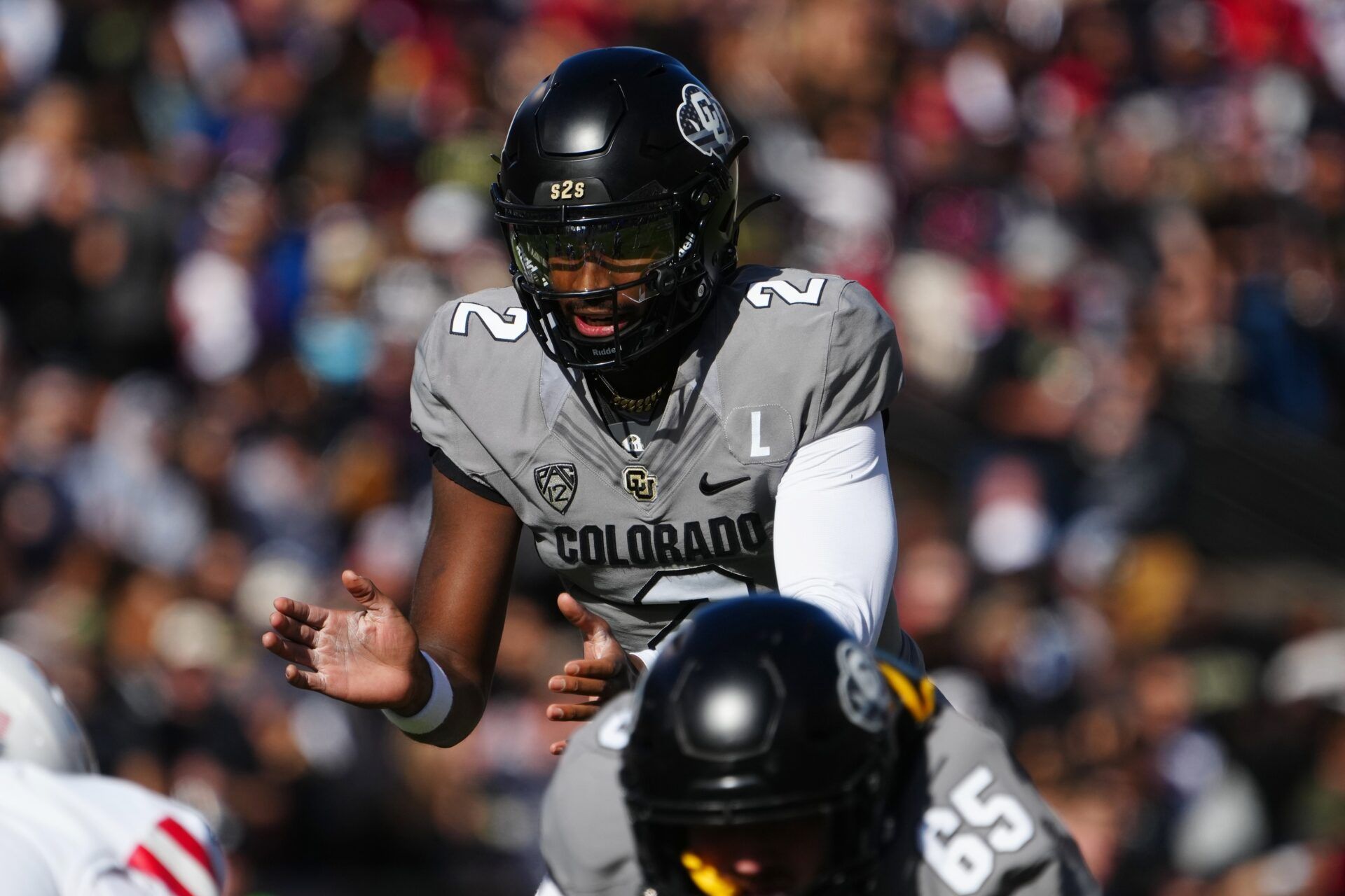 Colorado Buffaloes quarterback Shedeur Sanders (2) at the line of scrimmage in the first half against the Arizona Wildcats at Folsom Field.