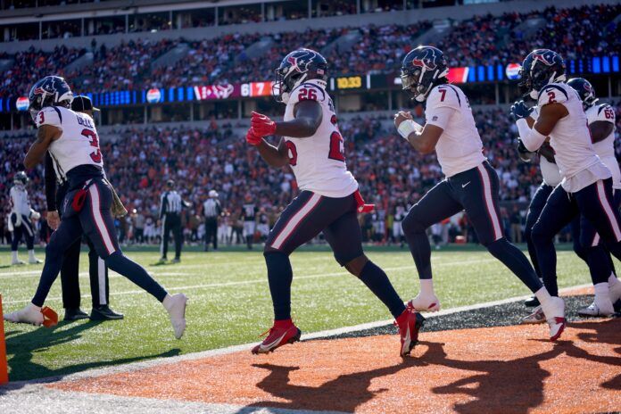 Houston Texans wide receiver Tank Dell (3), far left, leads a celebration with Houston Texans running back Devin Singletary (26), Houston Texans quarterback C.J. Stroud (7) and Houston Texans wide receiver Robert Woods (2) after a touchdown catch in the second quarter of a Week 10 NFL football game between the Houston Texans and the Cincinnati Bengals, Sunday, Nov. 12, 2023, at Paycor Stadium in Cincinnati.