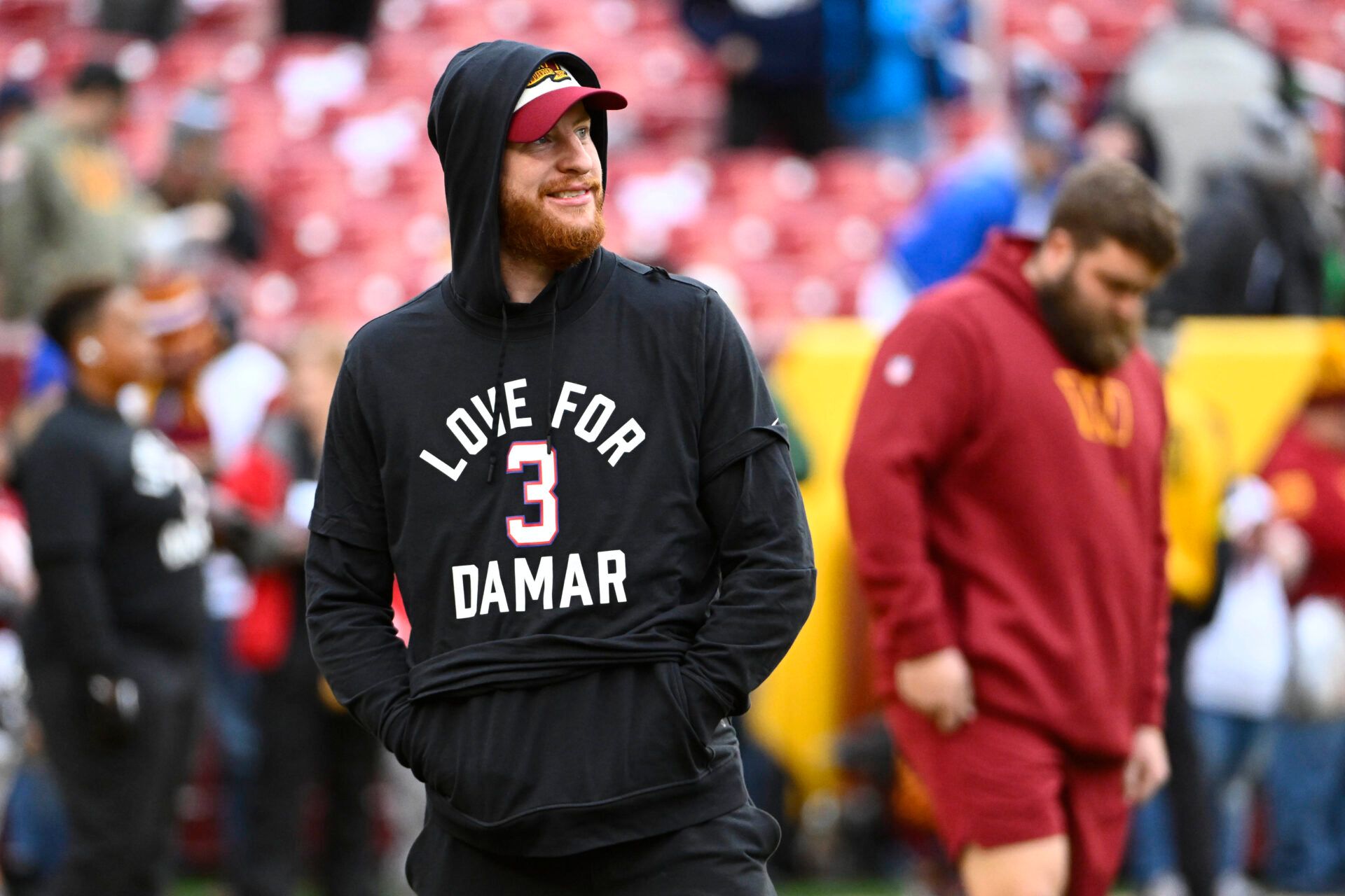 Washington Commanders quarterback Carson Wentz on the field wearing a shirt in support of Demar Hamlin before the game against the Dallas Cowboys at FedExField.