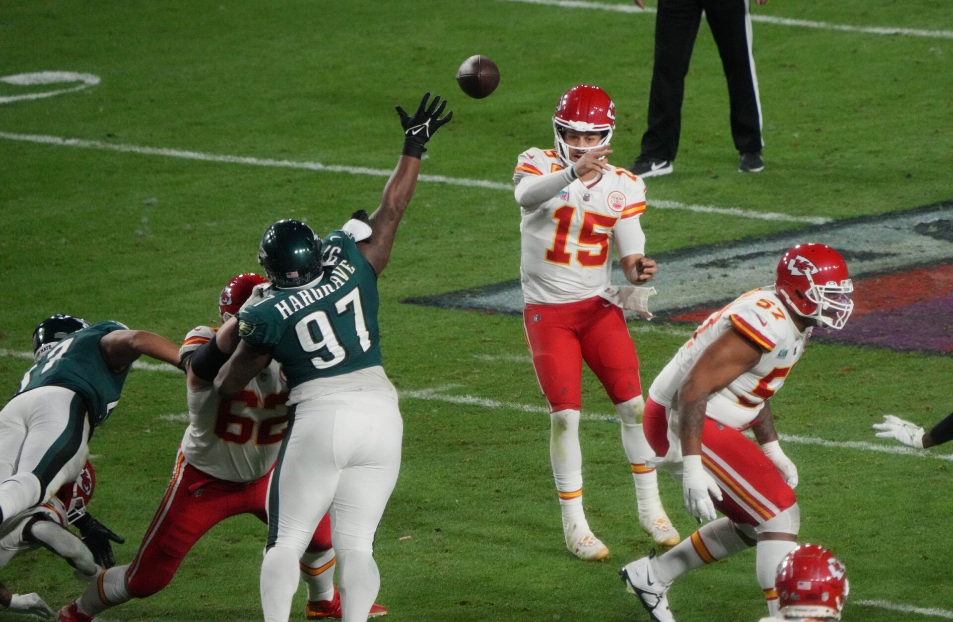 Patrick Mahomes (15) throws a pass over Philadelphia Eagles defensive tackle Javon Hargrave (97) in Super Bowl LVII at State Farm Stadium.
