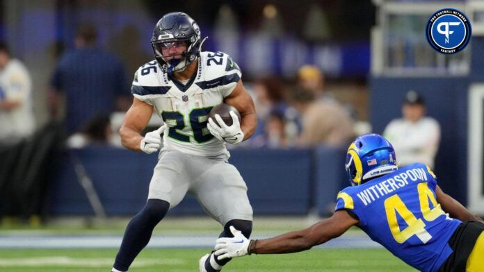 Zach Charbonnet (26) runs against Los Angeles Rams cornerback Ahkello Witherspoon (44) in the third quarter at SoFi Stadium.