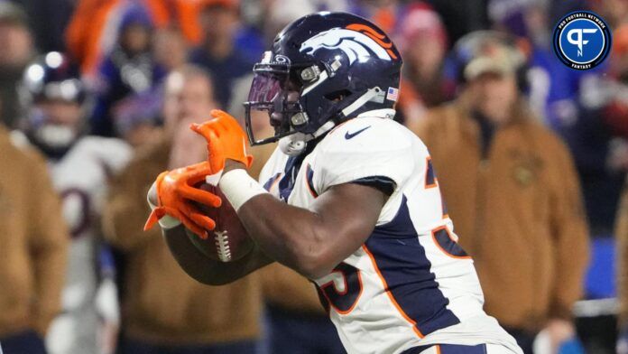 Javonte Williams (33) runs with the ball against the Buffalo Bills during the second half at Highmark Stadium.