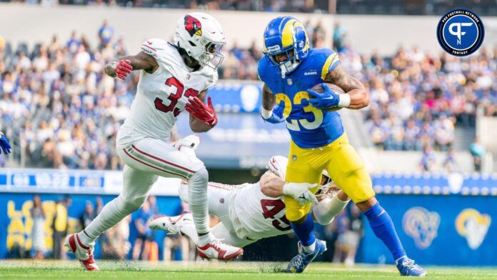 Los Angeles Rams running back Kyren Williams (23) runs the football against Arizona Cardinals cornerback Antonio Hamilton Sr. (33) and linebacker Dennis Gardeck (45).