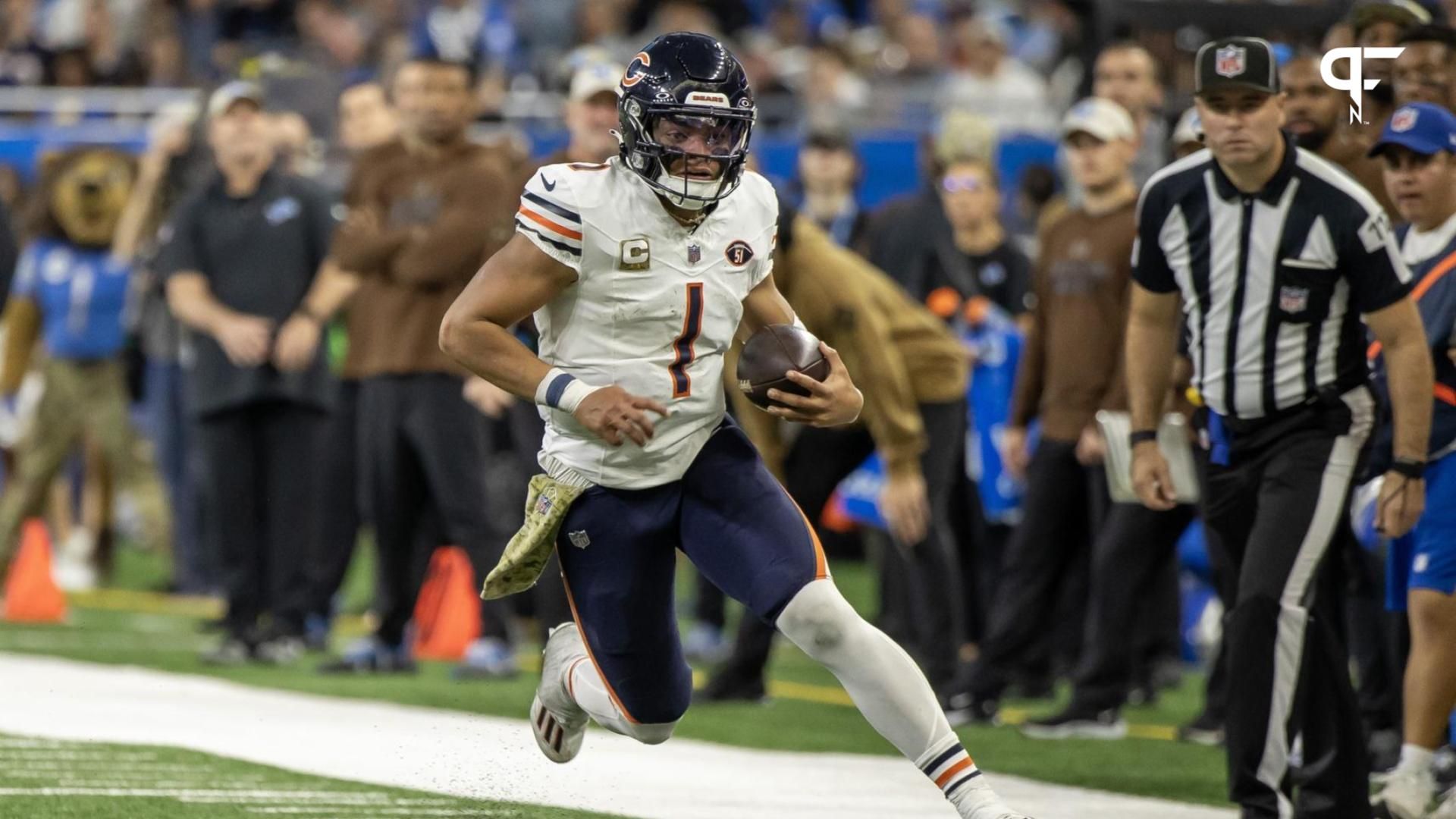 Justin Fields (1) runs with the ball against the Detroit Lions during the second half at Ford Field.