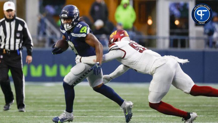 Seattle Seahawks running back Kenneth Walker III (9) rushes against Washington Commanders linebacker Jamin Davis (52) during the third quarter.