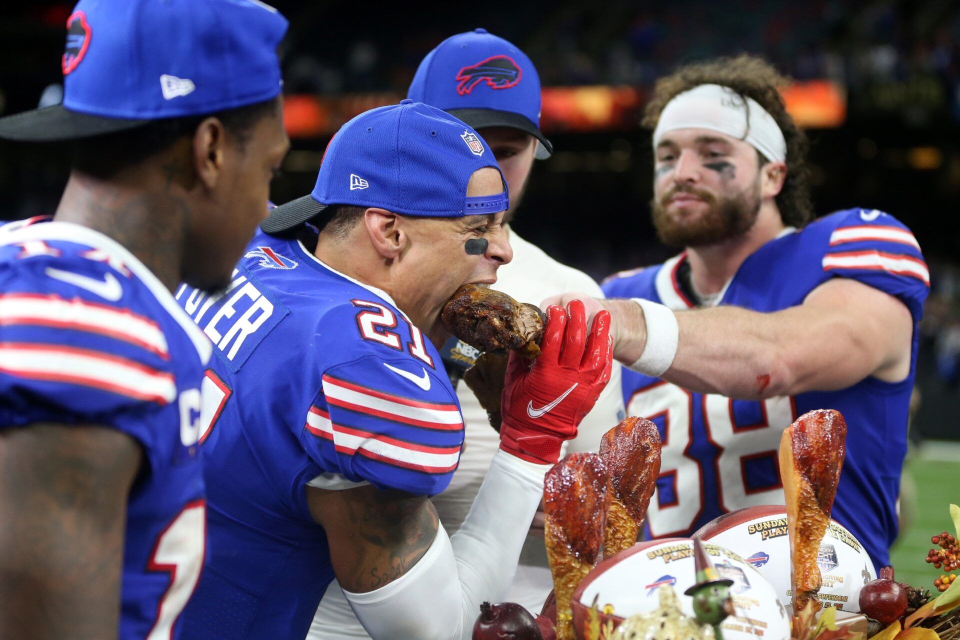 Buffalo Bills free safety Jordan Poyer (21) takes a bite of Dawson Knox s drumstick after their Thanksgiving game against the New Orleans Saints at the Caesars Superdome.