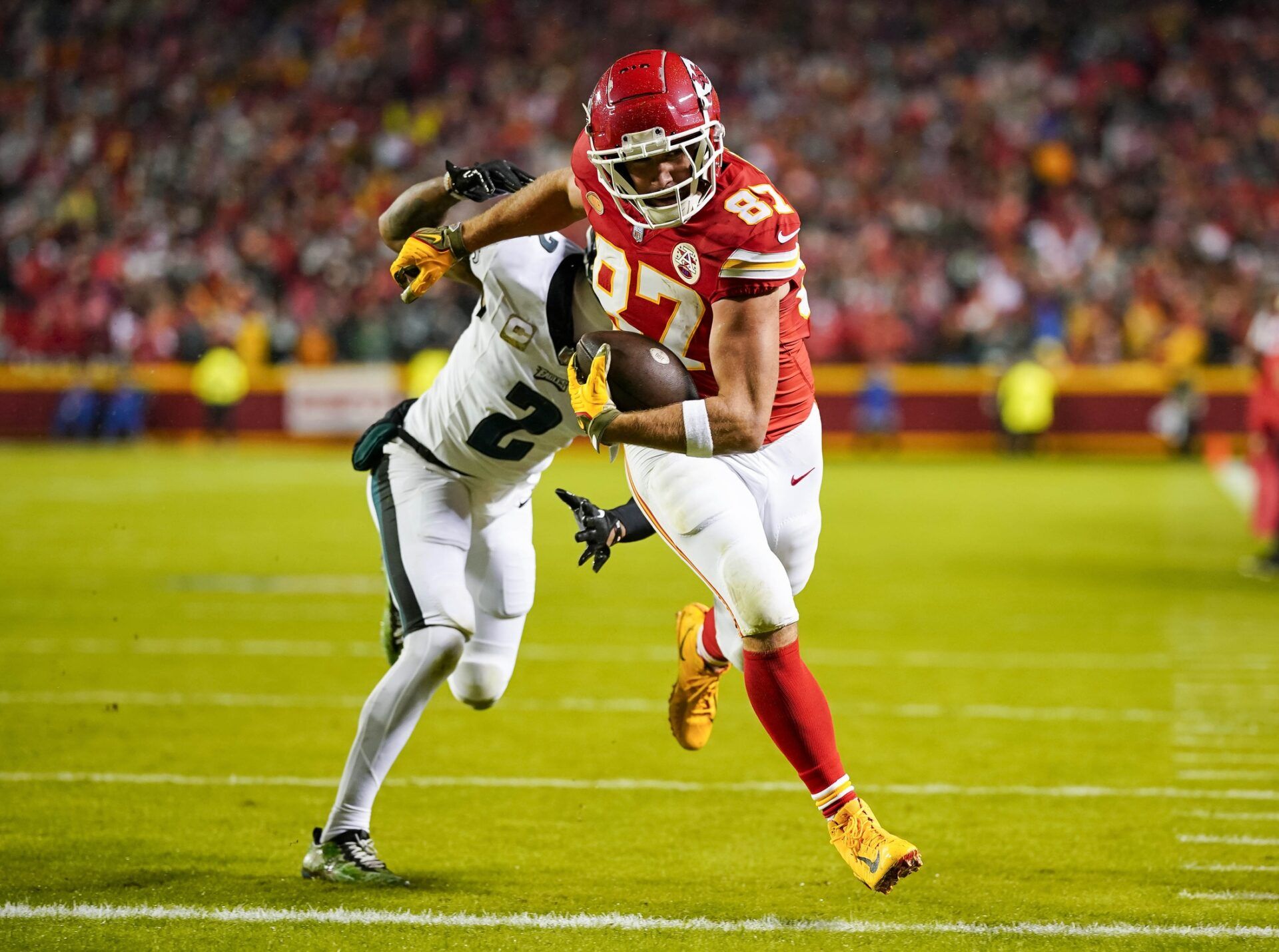 Kansas City Chiefs tight end Travis Kelce (87) scores a touchdown against Philadelphia Eagles cornerback Darius Slay (2) during the first half at GEHA Field at Arrowhead Stadium.