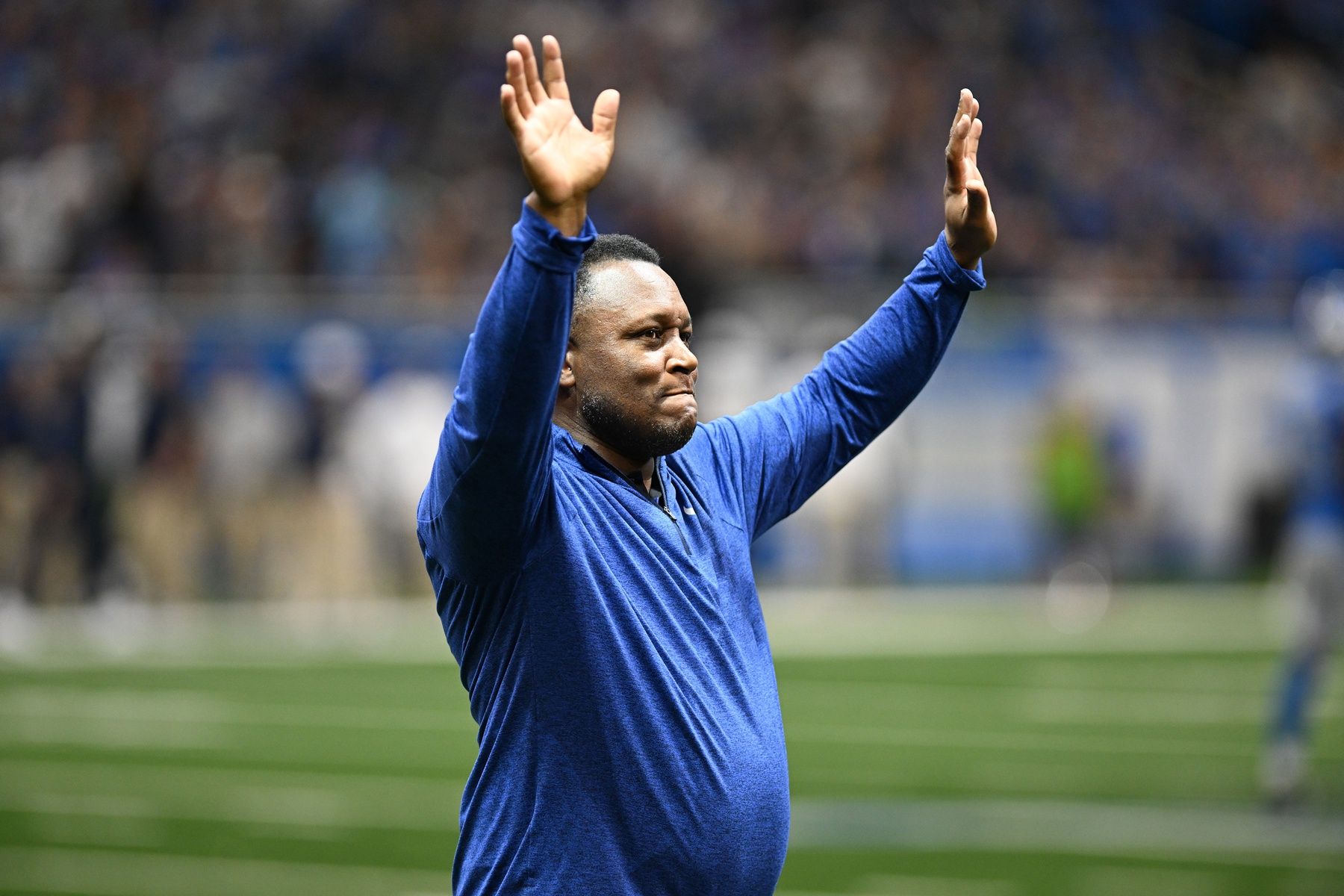 Former Detroit Lions Hall of Fame running back Barry Sanders acknowledges the crowd while being honored by the Lions.