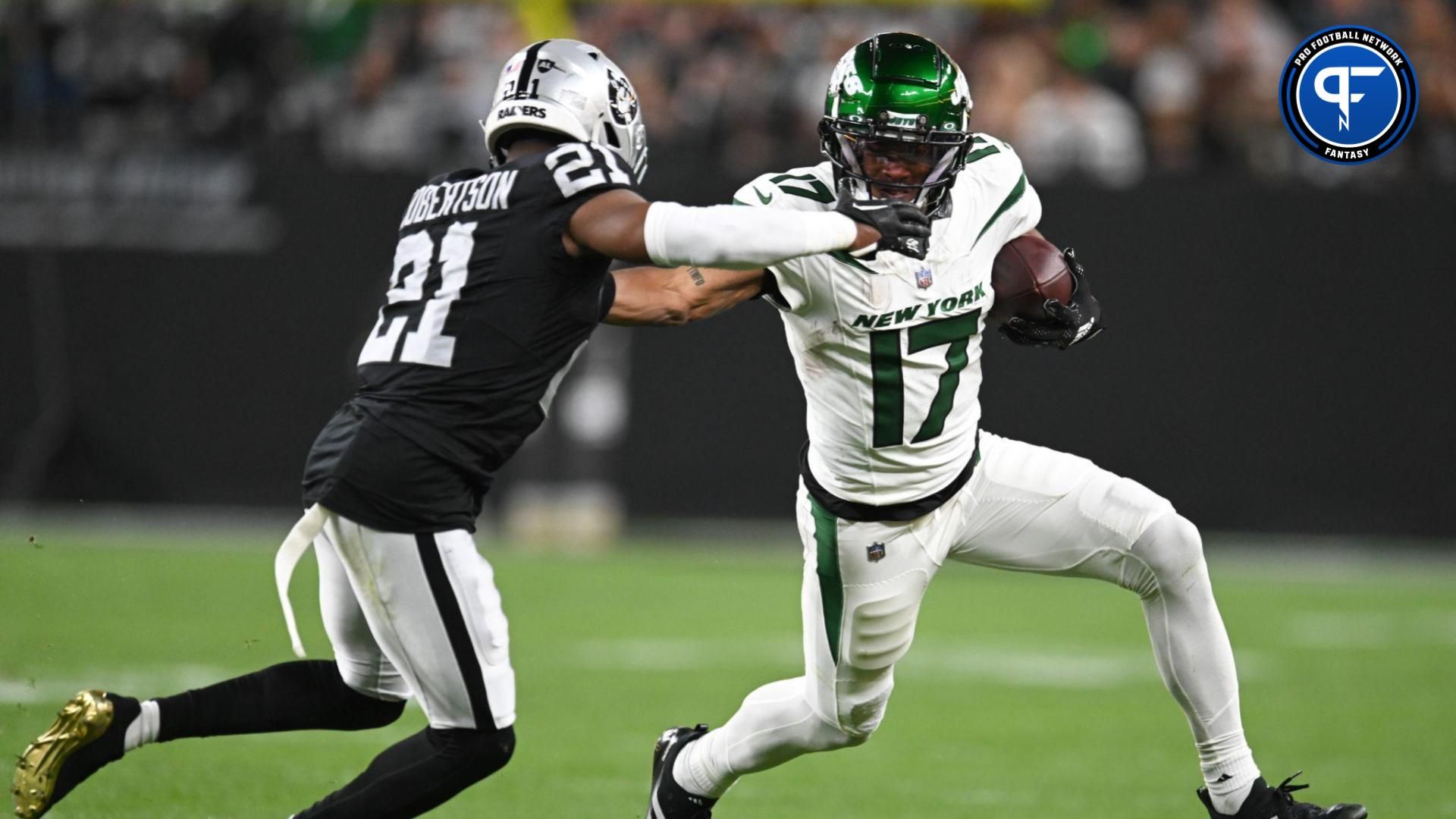 New York Jets wide receiver Garrett Wilson (17) runs past Las Vegas Raiders cornerback Amik Robertson (21) in the first quarter at Allegiant Stadium.