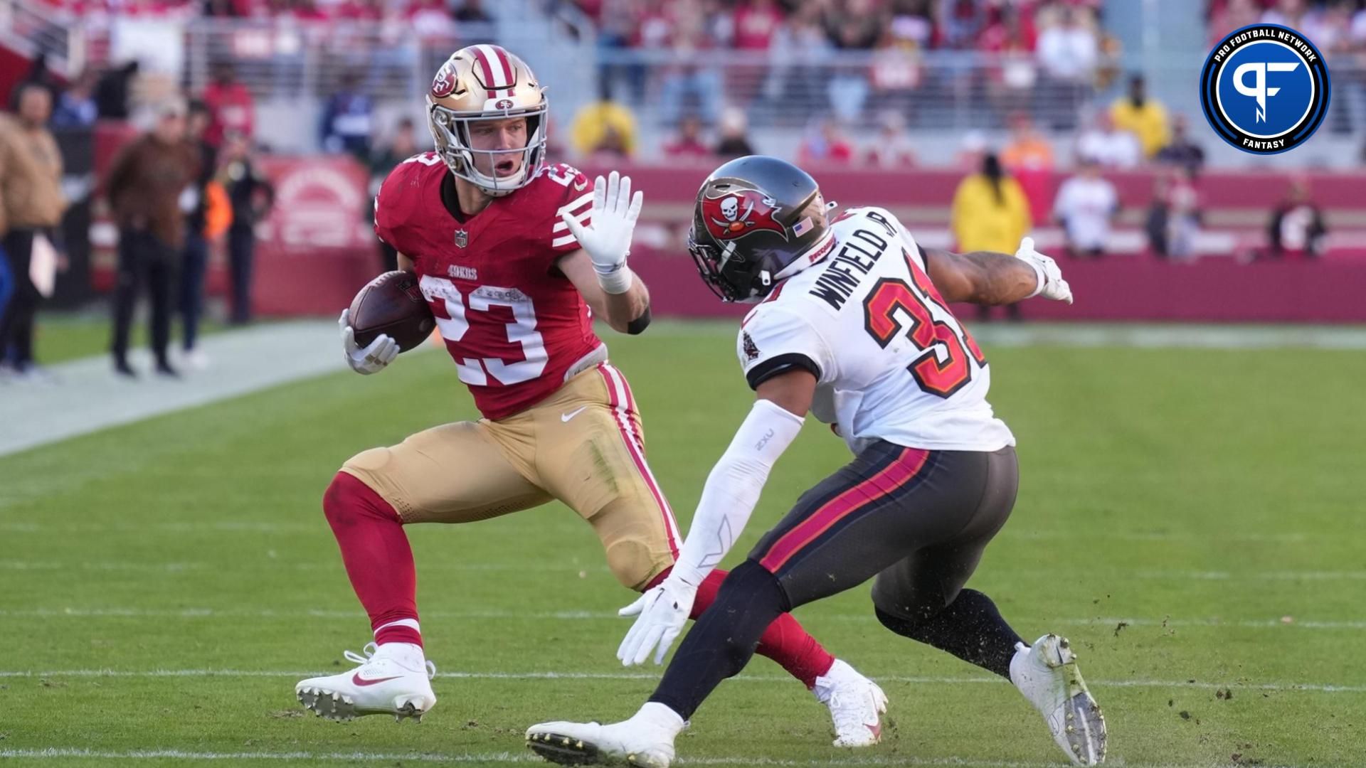 San Francisco 49ers running back Christian McCaffrey (23) carries the ball against Tampa Bay Buccaneers safety Antoine Winfield Jr. (31).