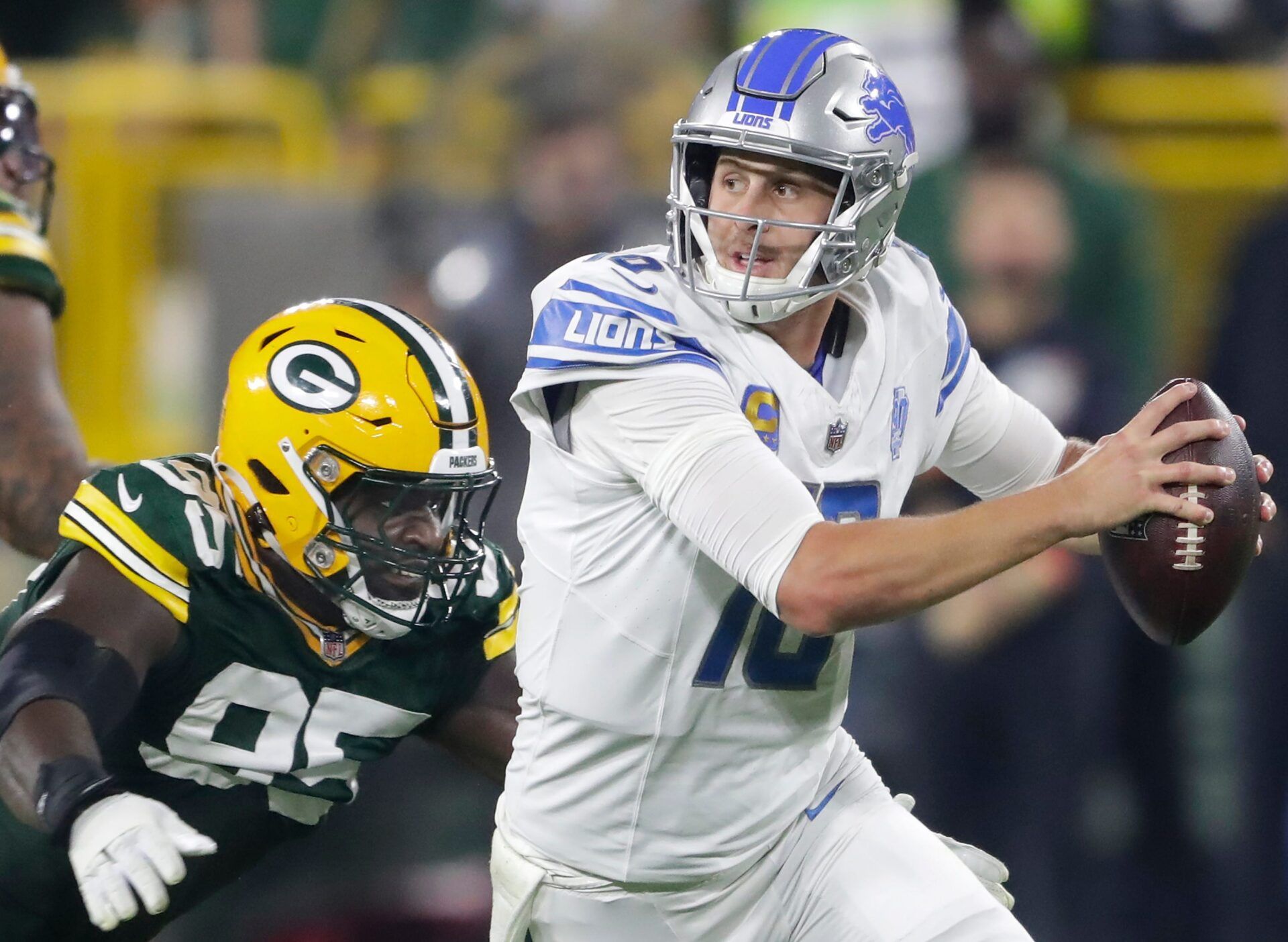 Green Bay Packers defensive tackle Devonte Wyatt (95) chases Detroit Lions quarterback Jared Goff (16) during their football game