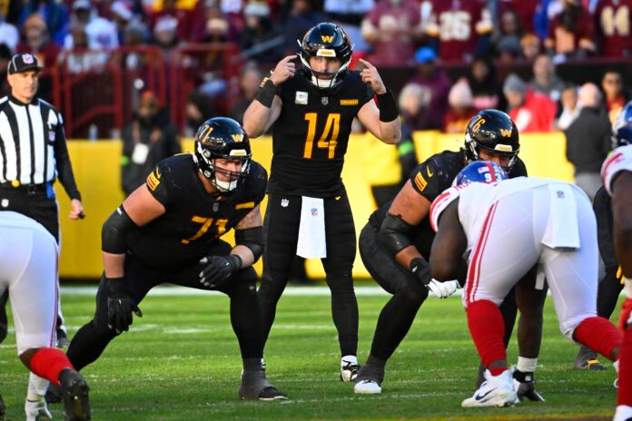 Commanders quarterback Sam Howell (14) at the line of scrimmage against the New York Giants during the second half at FedExField.