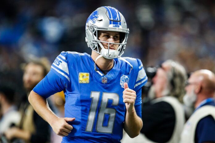 Detroit Lions quarterback Jared Goff runs off the field at halftime.