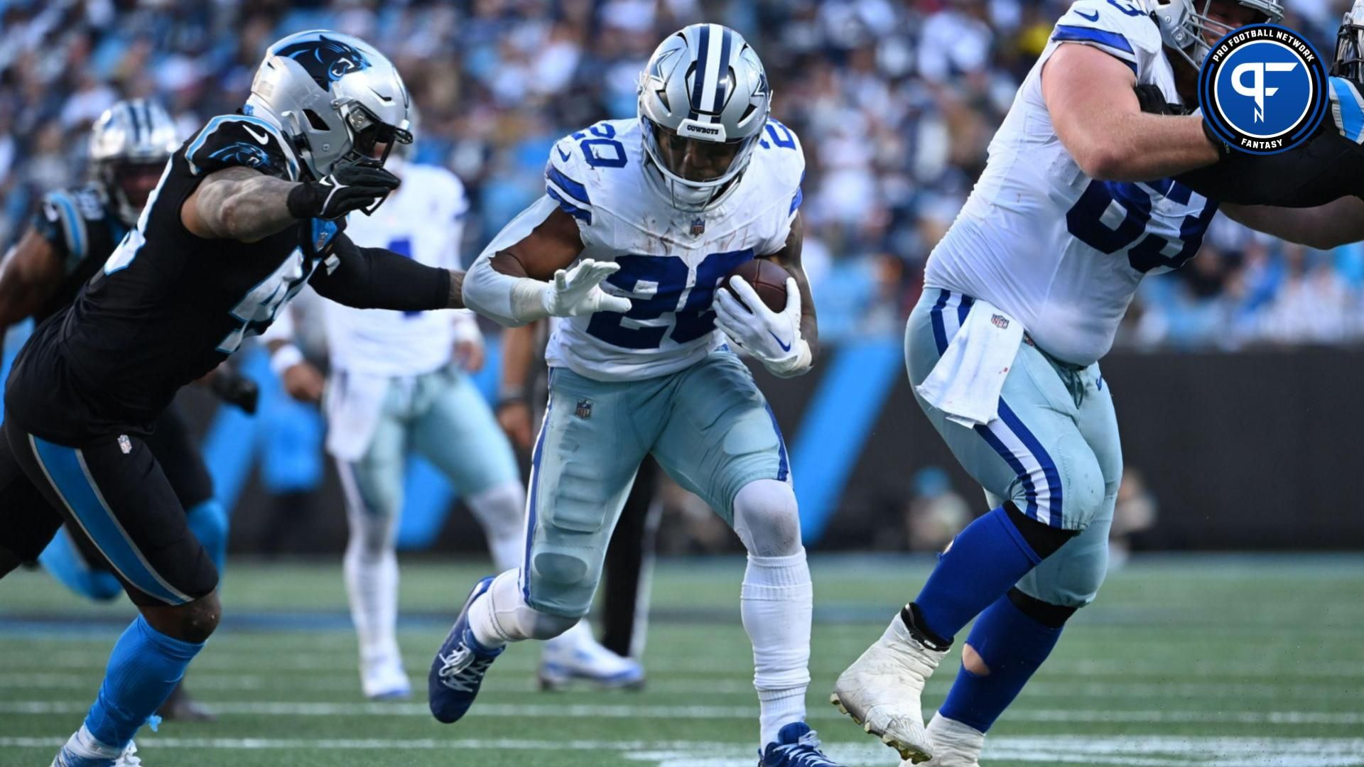 Dallas Cowboys running back Tony Pollard (20) runs as center Tyler Biadasz (63) blocks and Carolina Panthers linebacker Frankie Luvu (49) defends in the fourth quarter at Bank of America Stadium.