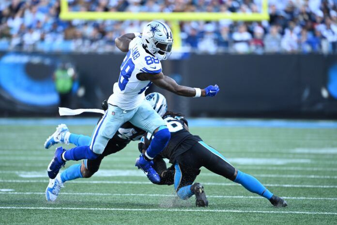 CeeDee Lamb (88) with the ball as Carolina Panthers linebacker Frankie Luvu (49) and cornerback Donte Jackson (26) defend in the fourth quarter at Bank of America Stadium.