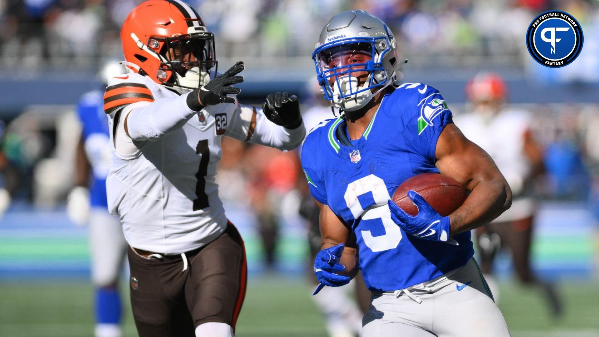 Kenneth Walker III (9) carries the ball while Cleveland Browns safety Juan Thornhill (1) chases during the first half at Lumen Field.