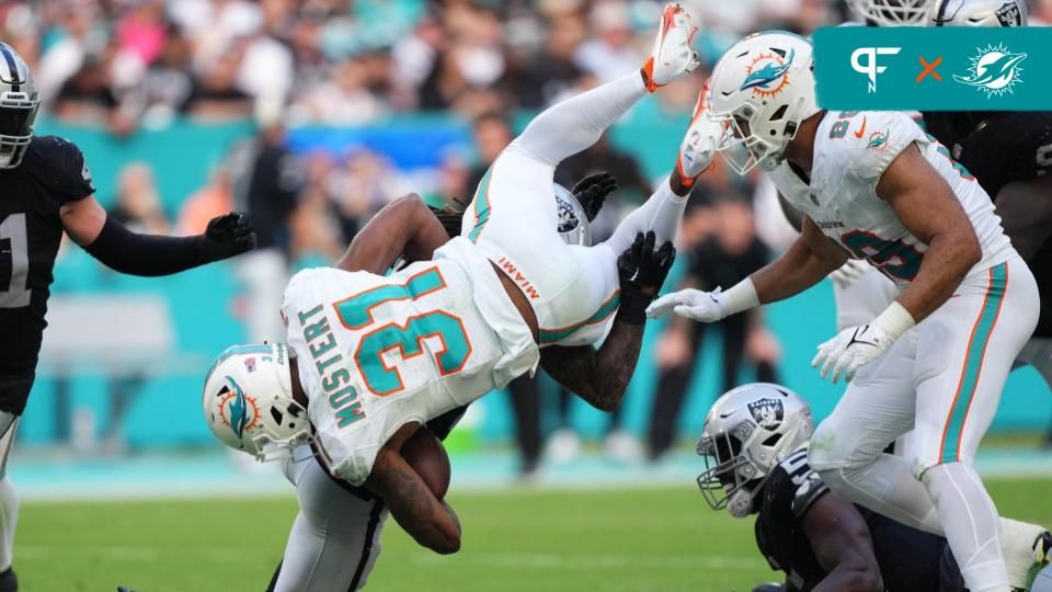 Las Vegas Raiders safety Tre'von Moehrig (25) upends Miami Dolphins running back Raheem Mostert (31) during the second half at Hard Rock Stadium.