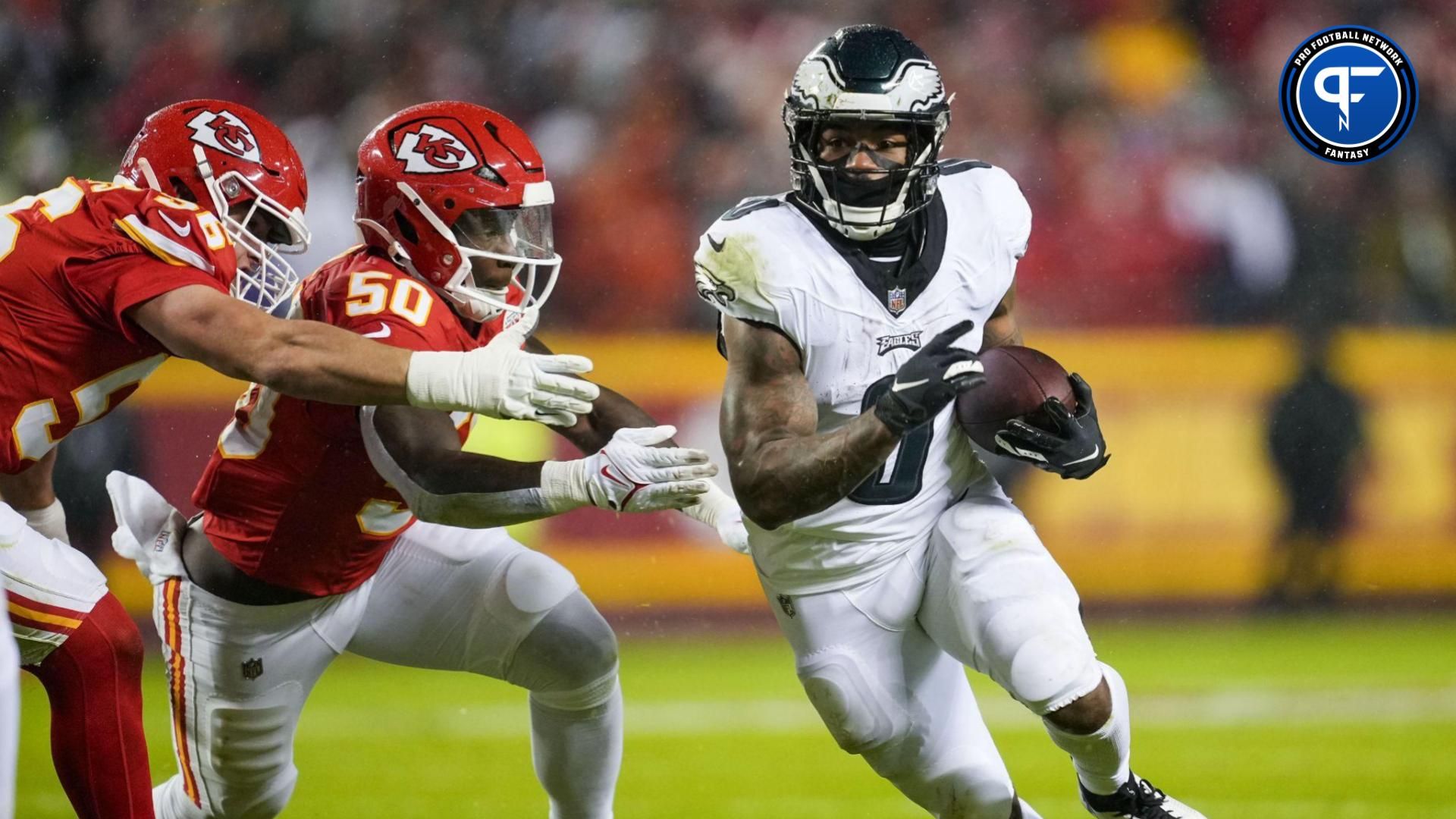 Philadelphia Eagles running back D'Andre Swift (0) runs the ball against Kansas City Chiefs linebacker Willie Gay (50) and defensive end George Karlaftis (56) during the first half at GEHA Field at Arrowhead Stadium.