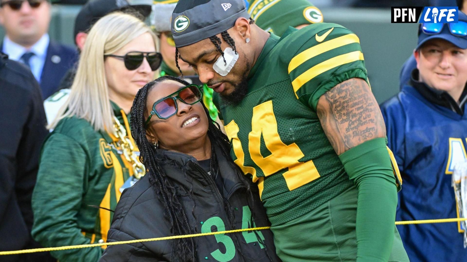 Green Bay Packers safety Jonathan Owens (34) hugs his wife, Olympic gymnast Simone Biles, before game against the Los Angeles Chargers at Lambeau Field.