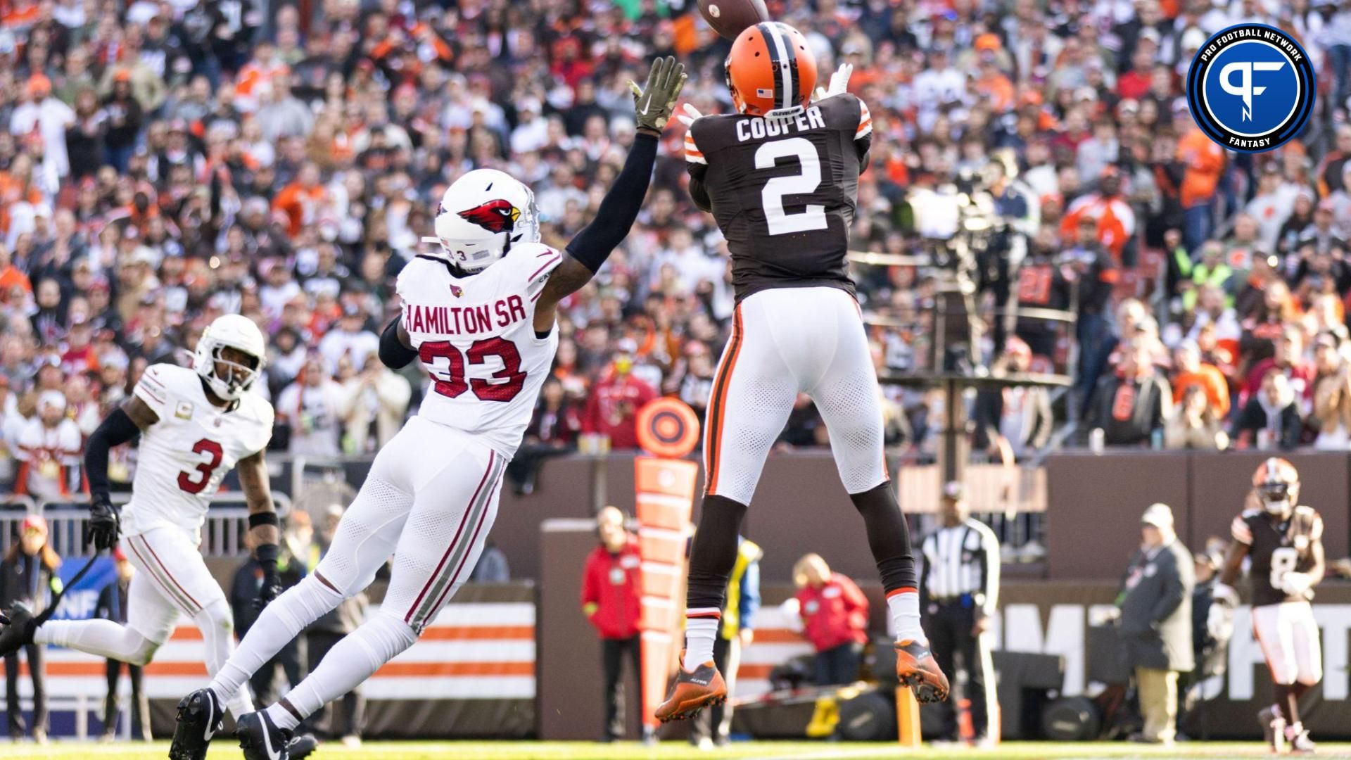 Cleveland Browns wide receiver Amari Cooper (2) catches a tipped ball for a touchdown under coverage by Arizona Cardinals cornerback Antonio Hamilton Sr. (33) during the second quarter at Cleveland Browns Stadium.