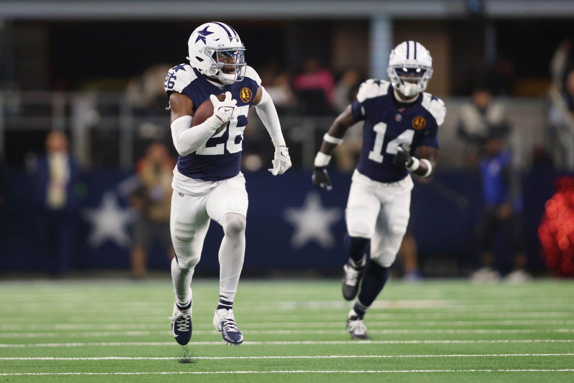 Dallas Cowboys cornerback DaRon Bland (26) returns an interception for a touchdown in the fourth quarter against the Washington Commanders at AT&T Stadium.