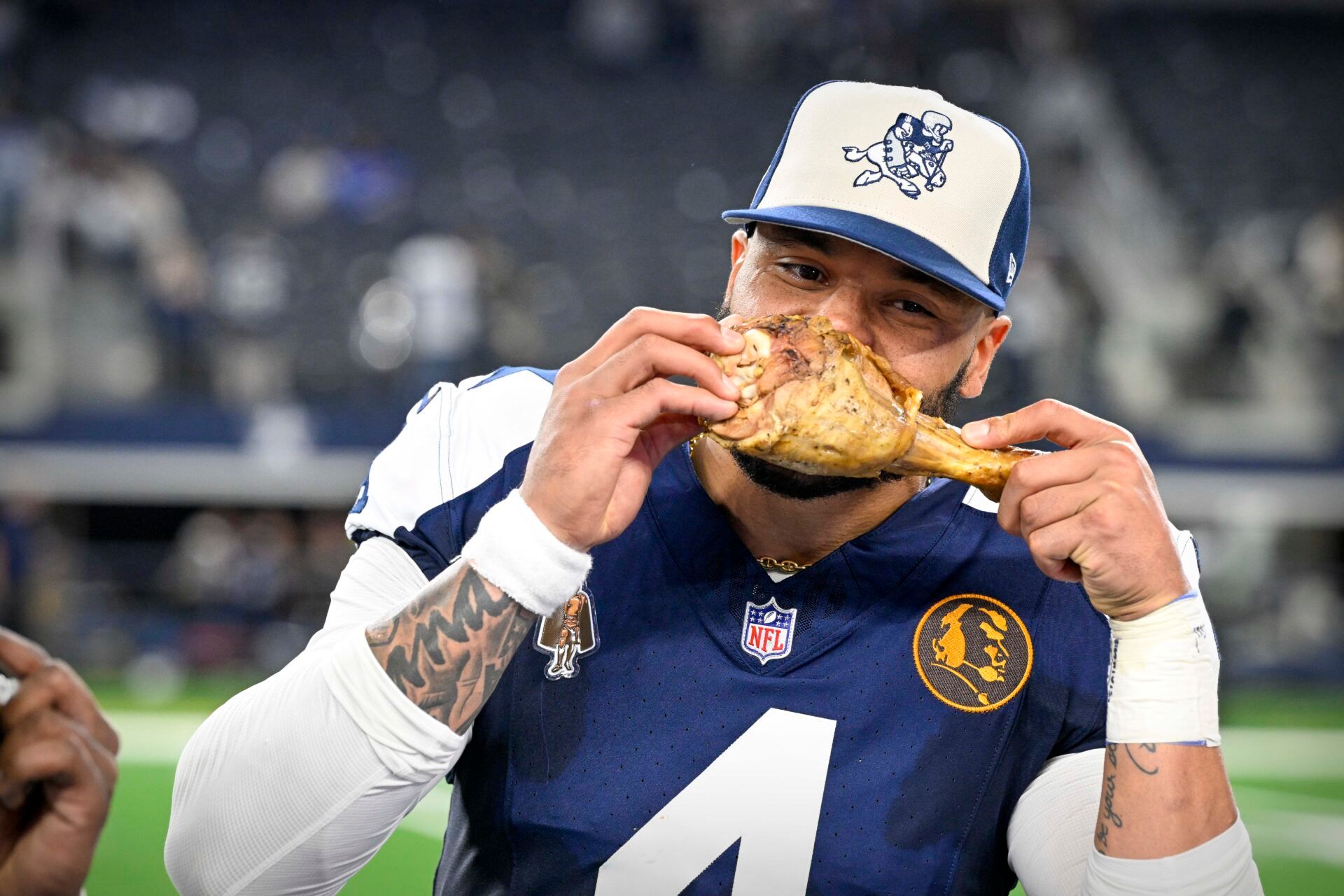 Dallas Cowboys Dak Prescott (4) eats a turkey leg after the Cowboys victory over the Washington Commanders at AT&T Stadium.