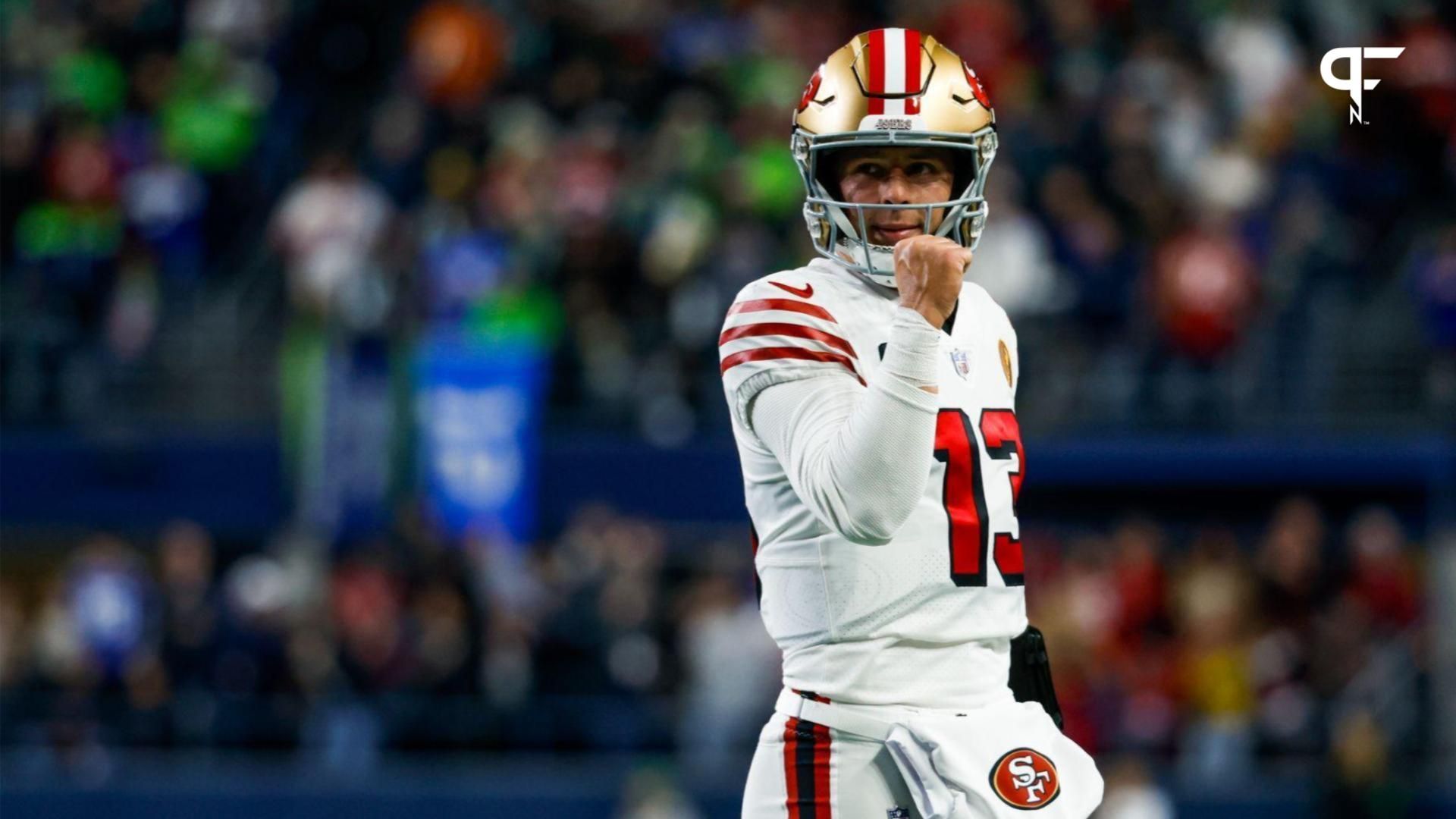 San Francisco 49ers quarterback Brock Purdy (13) reacts following a rushing touchdown by wide receiver Deebo Samuel (19, not pictured) against the Seattle Seahawks during the first quarter at Lumen Field.