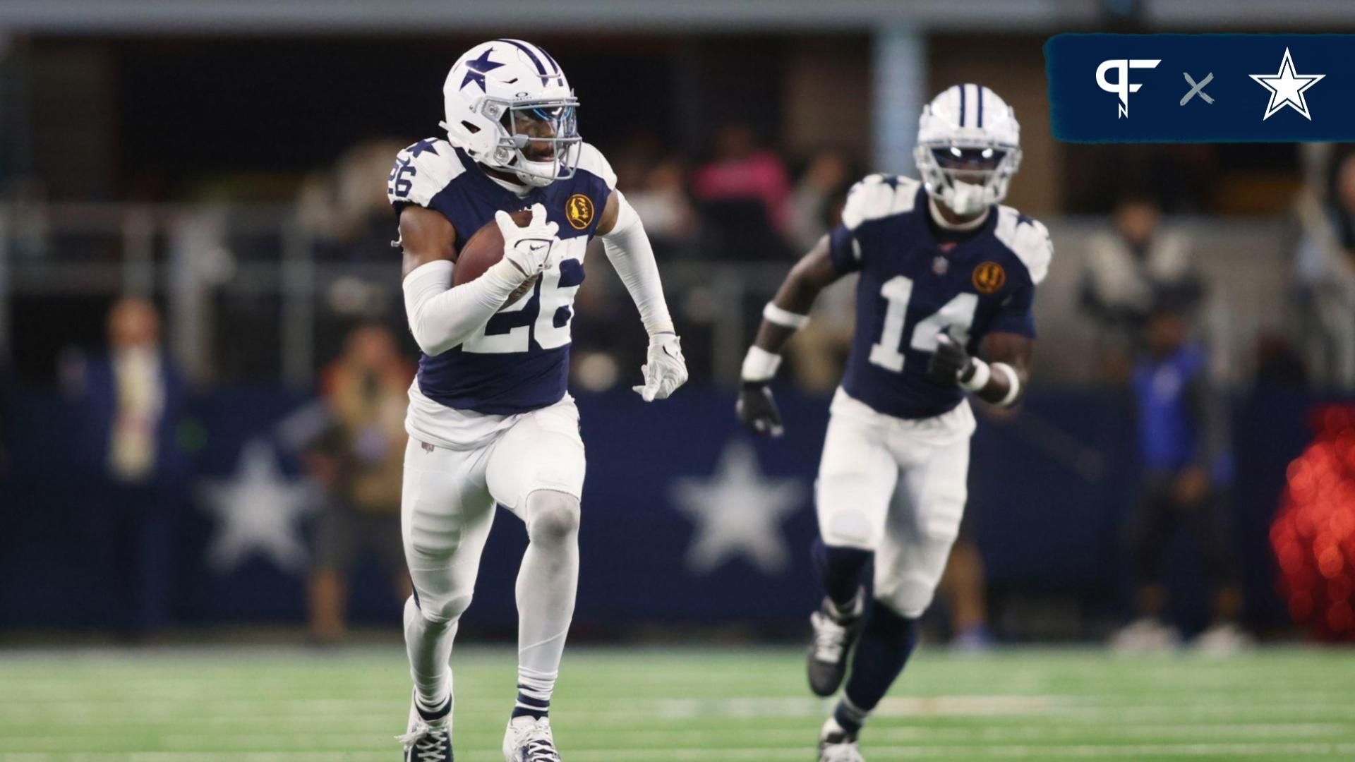 Dallas Cowboys cornerback DaRon Bland (26) returns an interception for a touchdown in the fourth quarter against the Washington Commanders at AT&T Stadium.