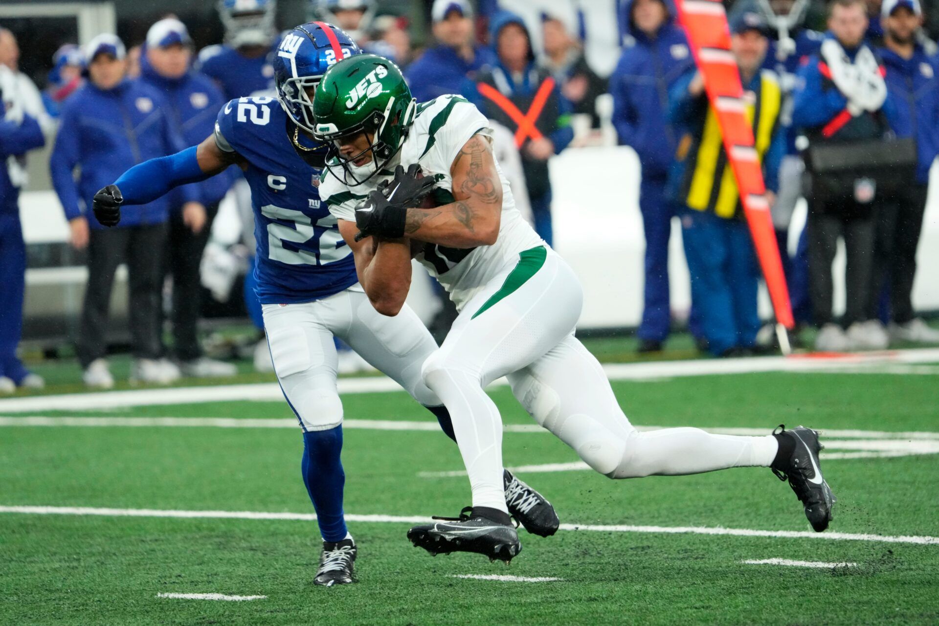 New York Jets wide receiver Allen Lazard (10) runs with the ball before being stopped by New York Giants cornerback Adoree' Jackson (22) in the fourth quarter.