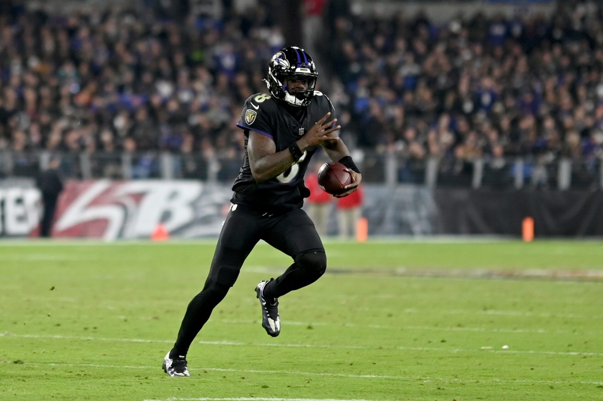 Baltimore Ravens quarterback Lamar Jackson (8) scrambles during the third quarter against the Cincinnati Bengals at M&T Bank Stadium.