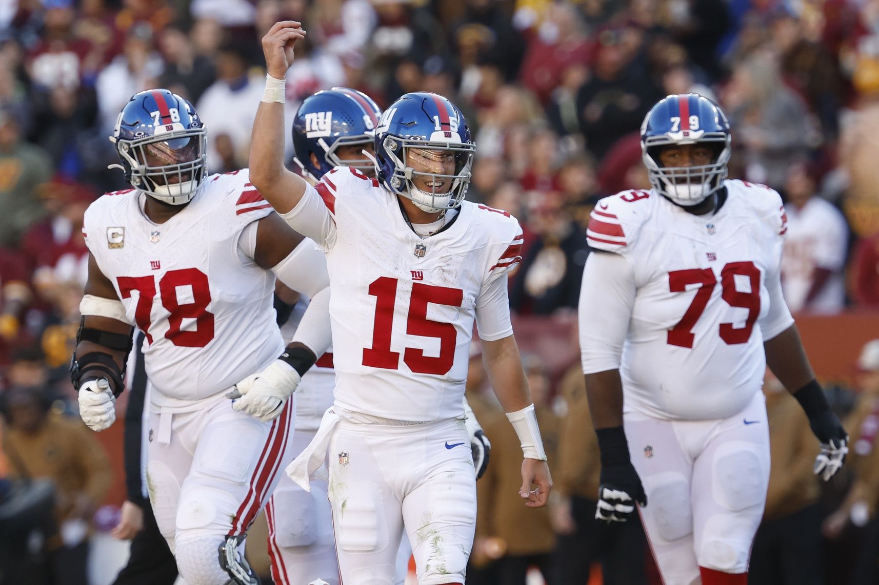 New York Giants quarterback Tommy DeVito (15) celebrates after throwing a touchdown pass against the Washington Commanders during the second quarter at FedExField.